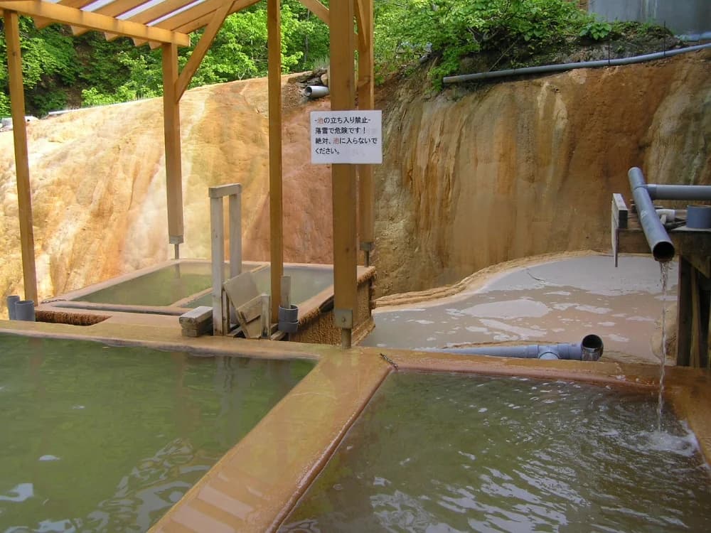 Futamata Radium Hot Spring outdoor bath, Oshamanbe, Hokkaido, Japan — source of the Tufa mineral stones used in the Anespa DX ceramic cartridge